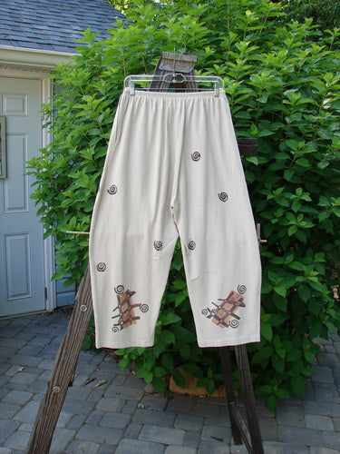 Image alt text: "1994 Wanderer's Pant Tic Tac Mist Size 1: Medium weight cotton jersey pants with spirals and snails, side entry front pockets, crop length, widened hip shape, and Tic Tac Toe and swirl theme paint."