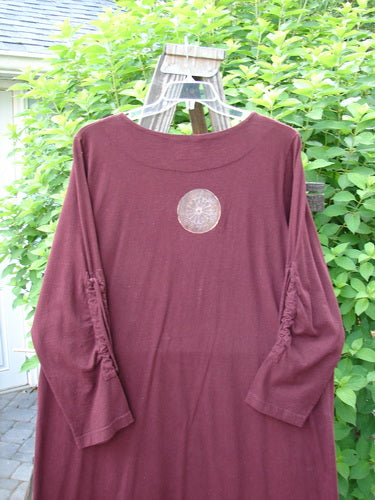 1999 Starlight Dress: Deep burgundy long-sleeved shirt with Celtic compass design. Lovely sleeve lacings, straighter longer shape. Perfect condition.