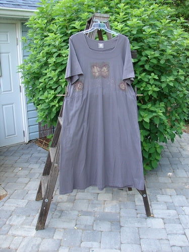 Image alt text: 1999 Windmill Dress Butterfly Raven Size 2 - A flattering mid-weight organic cotton dress with a butterfly and nature theme paint design. Sweeping A-line shape, squared neckline, yoked waist, and flared hemline. Features deep side pockets and Blue Fish patch.