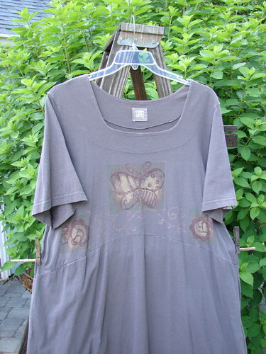 1999 Windmill Dress Butterfly Raven Size 2: A grey shirt with a butterfly on it, featuring a sweeping A-lined shape, double-paneled neckline, and flared hemline.