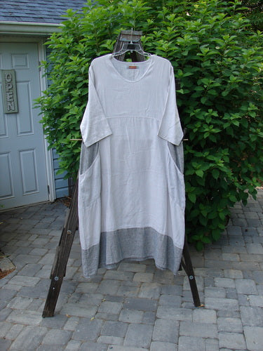 Image alt text: Barclay Linen Stripe Tulip Dress on wooden rack, with scoop neckline, oversized side pockets, and tulip bottom flare. Size 1.