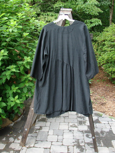 2000 Shaunting Silk Smooth Slant Wrap Jacket Unpainted Black Size 2: A black silk wrap jacket with wide rounded sleeves and a slanted gathered back seam.