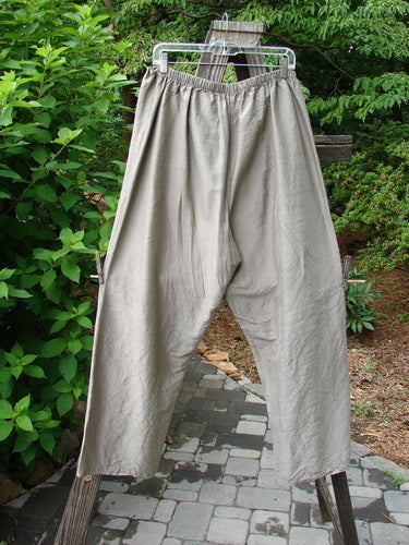 A pair of 2000 Shaunting Silk Slant Drawcord Pants in Cement, size 2. Rear elastic waistband with drawcord front. Wider hips and lowers. Classic Transitions theme. Lengthy inseam and full length. Waist relaxed 26 to 56, waist extended 56, hips 56, inseam 26, length 40 inches.