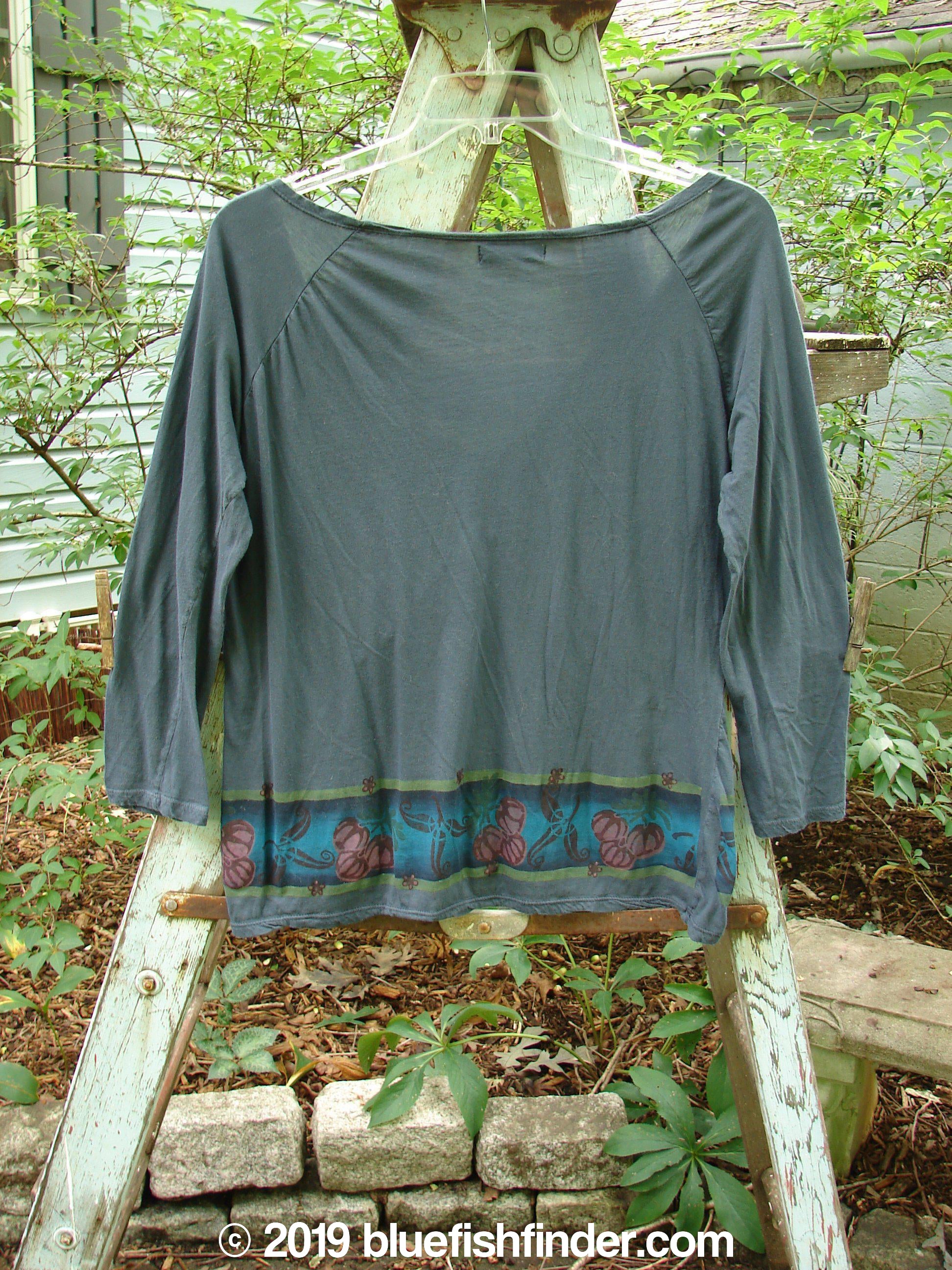 Barclay Batiste Decora Gather Top Gourd Farm Navy Size 1: A grey shirt on a ladder, featuring a deep V neckline, adjustable drawcord accent, and gentle pleats on the shoulders.