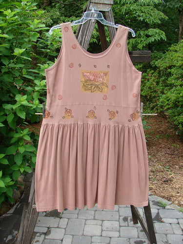 1993 Tier Dress Water Lilly Dried Rose Size 2: A pink dress on a clothes rack with a flower design. Perfect condition, made from cotton. Lovely banded drop waistline, super bottom flounce, and baby doll pleats. Bust 50, waist 52, hips 60, length 36 inches.