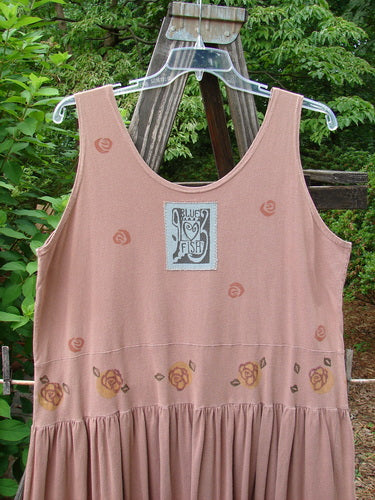 1993 Tier Dress Water Lilly Dried Rose Size 2: A pink tank top with a logo on it, featuring a close-up of a logo.