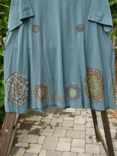 1993 Vagabond Dress with Metallic Pinwheel design, made from medium weight cotton, in grey green. A-line shape with V-shaped neckline and interesting V inserts. Vintage rounded sweeping lower.