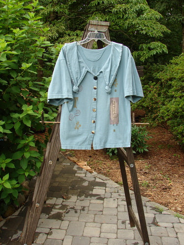 Image alt text: 1994 Compass Top Chair Dusk Size 1, blue shirt with a design on a clothes rack, featuring a big pointed over collar and original BF buttons.