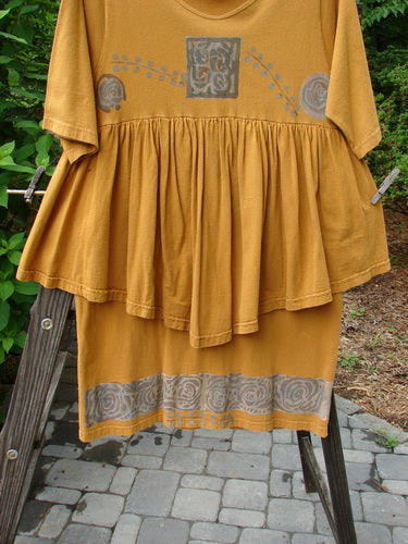 1993 Picnic Dress Windy Berries Oro OSFA: A yellow dress on a clothes rack, featuring a flirty continuous flounce and vintage signature patch.
