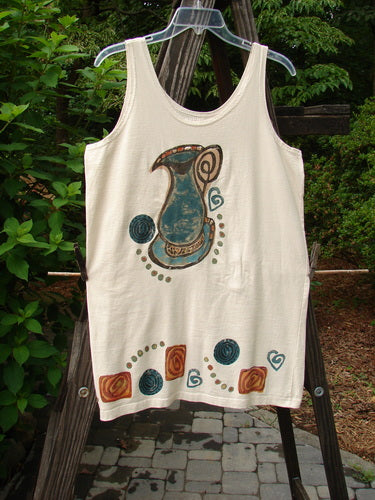 Image: A white tank top with a blue pitcher on it, featuring a close-up of a blue bird, a plastic swinger with a hole in the middle, a close-up of a stone floor, a white towel with a design on it, and a close-up of a plant.

Alt text: 1993 Little Tank Dress Vase Tea Dye OSFA: Vintage Blue Fish Clothing with a blue pitcher and nature-inspired details.