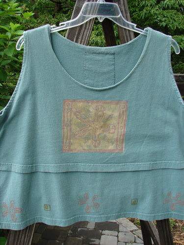 1993 Parallel Top Single Blossom Ocean OSFA: A blue tank top with a gold design on it, featuring a crop A-line cut, seriously rounded neckline, and double-layered bodice. Perfect for swinging in style!