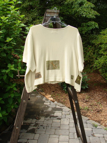 Image alt text: 2000 Patched Recycle Jacket Science Natural Size 2 - A white shirt with a design on it, hanging on a rack.