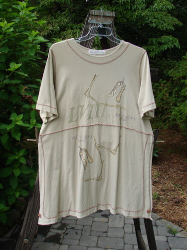 1998 Botanicals Snapdragon Top Echinacea Toadstool Size 2: A t-shirt with a graphic design on it, featuring a lovely flared shape, rounded neckline, and tall vented sides. Made from organic cotton, this top is perfect for a slim, no bulk look. Pair it with Creekside or Sparrow Lowers for a complete outfit. Bust: 52, Waist: 52, Hips: 52, Length: 35 inches.