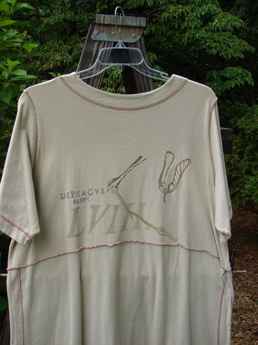 1998 Botanicals Snapdragon Top Echinacea Toadstool Size 2: A white shirt with a graphic design on it, featuring a lovely flared shape, rounded neckline, and tall vented sides. Accented by a single button and loop, with full exterior stitchery. Completely pocketless for a slim look.