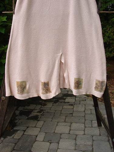 1994 Vent Vest Sweater Jumper Dragonfly Tea Dye Smaller OSFA: A pink skirt with a flower design on it, featuring a wooden post on a stone surface and a stone walkway with a pink cloth.