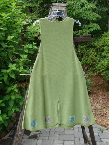 1994 Vent Vest Sweater Jumper Stars Kelp Smaller OSFA: A green dress on a clothes rack, featuring a slenderizing A-line shape, rear walking vent, and whimsical star paint.