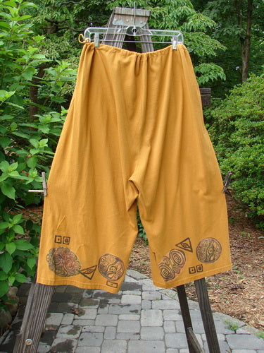 1993 Garden Pant Swirl Circle Oro Size 1: Funky crop pants with side ties, deep pockets, and vintage swirl circle theme paint.