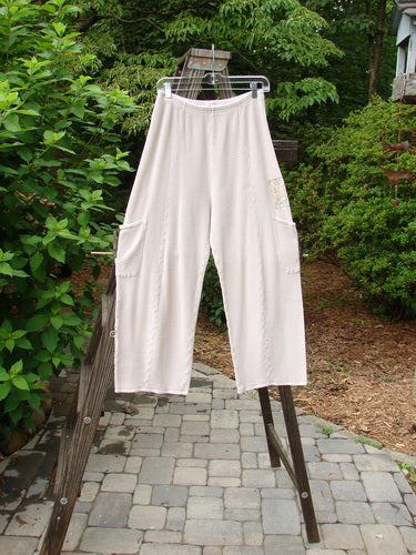 A pair of white pants with painted garden patches, full elastic waistline, and deeper drop exterior pockets. Size 1.
