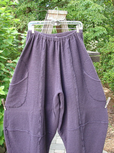 A pair of Barclay Crepe Sectional Pocket 4 Square Pants in Shadow, made from Heavy Weight Cotton Crepe. Features a unique bottom cut that drapes into a 3D diamond from the knee down. Complete with exterior wrap-around hip pockets, elastic waistband, and richly textured fabric. Unpainted and in perfect condition. Size 1.