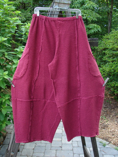 Barclay Crepe Sectional Pocket 4 Square Pant Unpainted Cranberry Size 1: A unique pair of pants with a 3D diamond cut from the knee down, featuring generous hip pockets, elastic waistband, and textured cotton crepe fabric.