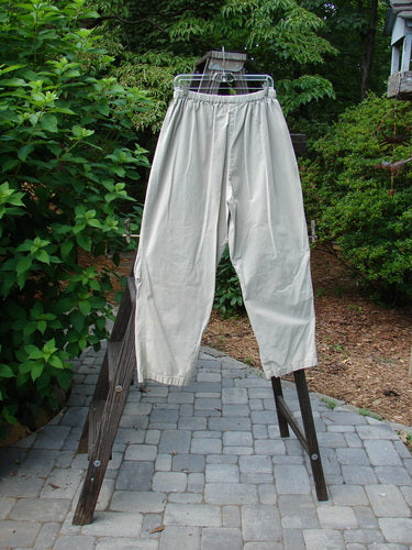 2000 Parachute Trekker Pant Unpainted Sand Size 2: A pair of pants on a rack, made from medium weight cotton parachute fabric. Features include additional knee fabric, slightly tapering lowers, and a full elastic waistline.