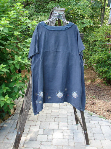 A navy Barclay Linen Sailor Dress with celestial theme paint, featuring a batiste adorned neckline, swaying lower hemline, and empire waist seam. Size 2.