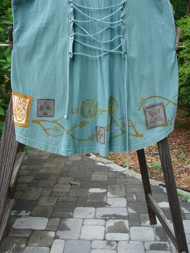 1993 Cha Cha Jumper Grey Green OSFA: A blue skirt with a design on it, featuring a squared off neckline, A-line flare, empire waist seam, and gathered bust area.