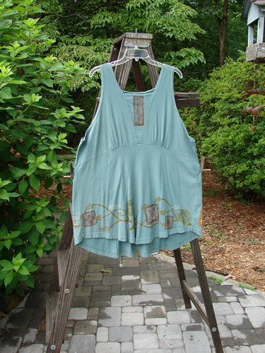 1993 Cha Cha Jumper Grey Green OSFA: Blue Fish dress on clothes rack, featuring branch and swirl block prints, squared off neckline, A-line flare, empire waist seam, and gathered bust area.