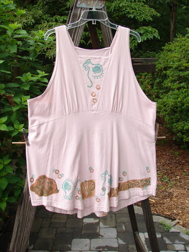 Image alt text: 1993 Cha Cha Jumper with seashell and swirl block prints on ash pink fabric, featuring a squared off neckline, A-line flare, empire waist seam, and gathered bust area.