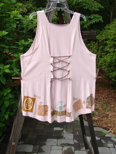 Image alt text: 1993 Cha Cha Jumper in Ash Pink with lace-up back, seashell and swirl block prints, and gathered bust area.