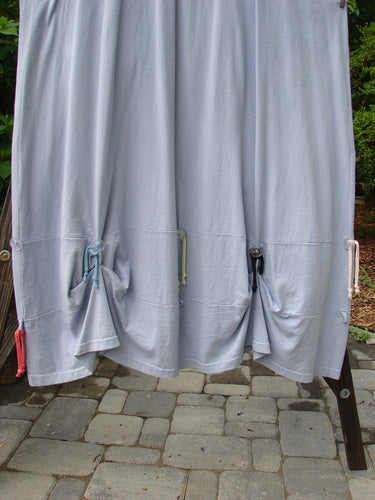 1997 Salt Water Taffy Jumper Rain Size 2: A white sheet with pink and blue ties, a close-up of a curtain, a person's legs on a stone walkway, and a close-up of a wood post.