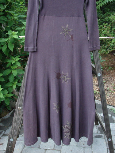 A 1998 Rib Top Dress Snowflake Morado Size 0: a purple dress with a pattern on it, hanging on a clothes rack.