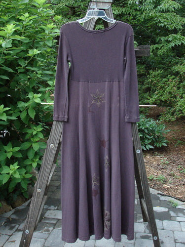 1998 Rib Top Dress Snowflake Morado Size 0: A long purple dress on a wooden ladder, featuring a stitched neckline, ribbed upper bodice, empire waist seam, and flowing lower.