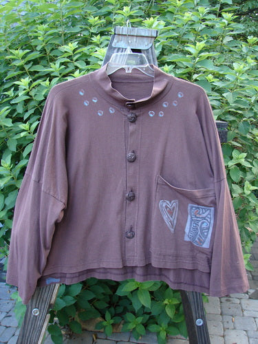 1996 Elements Mock T Neck Jacket Heart Spicewood OSFA: A brown jacket with a heart design, double buttoned neckline, wide swingy cut, and oversized front pocket.