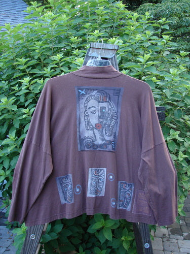 1996 Elements Mock T Neck Jacket Heart Spicewood OSFA: A brown jacket with a picture on it. Features a mock turtleneck, double-buttoned neckline, wide swingy cut, oversized front painted pocket, and colorful heart theme paint.