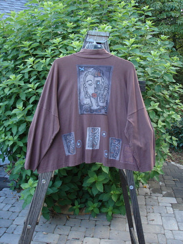 1996 Elements Mock T Neck Jacket Heart Spicewood OSFA: A brown jacket with a picture on it. Features a mock turtleneck, swingy cut, oversized front pocket, and colorful heart theme paint.