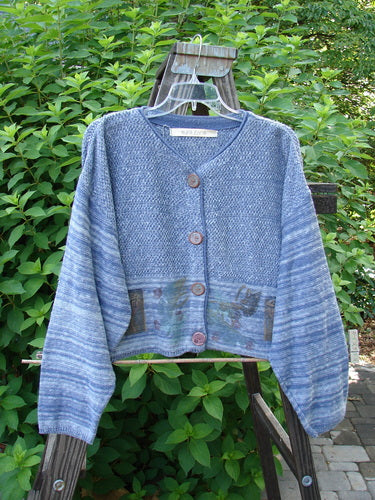 1994 Crop Cardigan Sweater featuring leaf and pod motifs in Haiku Blue Melange. Stoneware buttons, contrasting knits, and cozy longer sleeves.