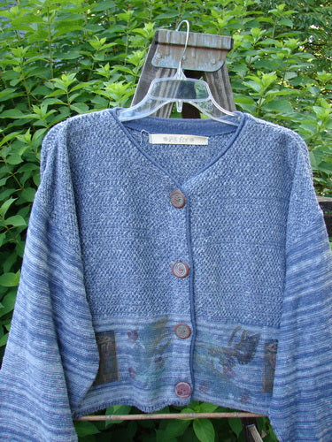 A 1994 Crop Cardigan Sweater in Haiku Blue Melange. Features include stoneware buttons, contrasting knits, and leaf and pod theme paint. Cozy and stylish.