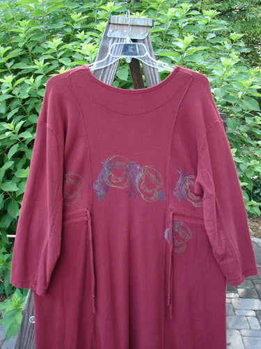 1999 Thermal Home Dress Farm Cinnamon Size 1: A red shirt with a design on it, featuring a squared off neckline, elbow patches, and unique sectional panels.
