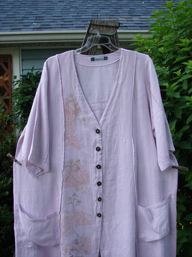 Barclay Linen Double Tie Back Jacket Wind Branch Pink Cloud Size 2: A purple shirt with a floral design, featuring a deep V-shaped neckline, A-line sweep, and front drop flop pockets.