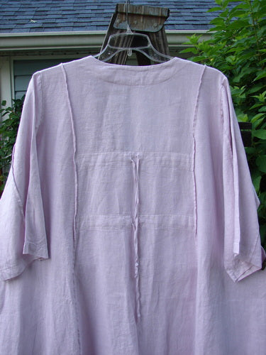 Barclay Linen Double Tie Back Jacket Wind Branch Pink Cloud Size 2: A purple shirt on a clothes rack, close-up of shirt, bell from a roof, close-up of purple shirt, and a swinger with a shirt on it.