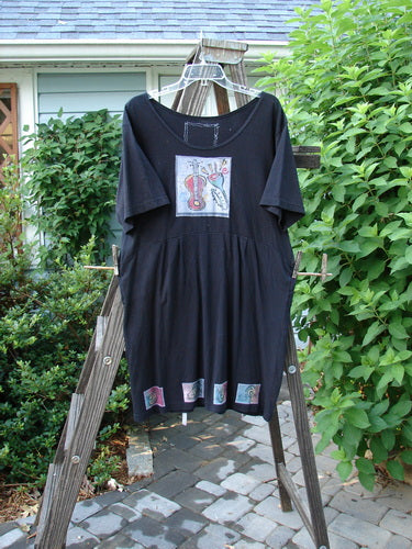 1992 Patched Little Storma dress with music-themed patches and Blue Fish vintage patch on black cotton.