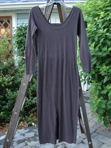 A 1992 Cotton Lycra Back Vent Dress in Black Sand, Size 2. Features include an hourglass shape, rear kick vent, V front, and pegged hemline. Perfect for layering.