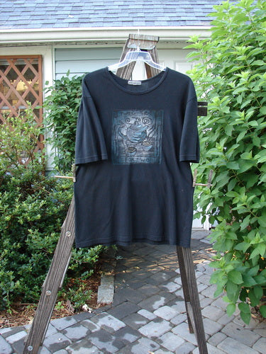 A black short-sleeved tee with a Tea For Two theme paint design. Made from organic cotton. Perfect condition. Size 0.
