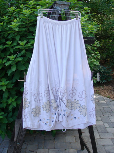 Barclay Spring Shade Skirt, a white skirt with a flower design on it. Drapes fabulously with a varying hemline when gathered. Made from organic cotton.