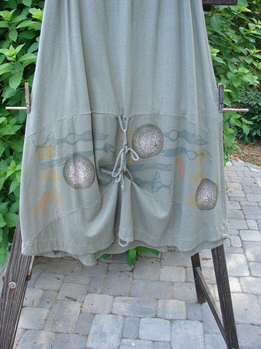 2000 Cotton Hemp Shade Skirt Biology Loden Size 2: A grey skirt with a design on it, featuring a full elastic waistband and varying hemline.