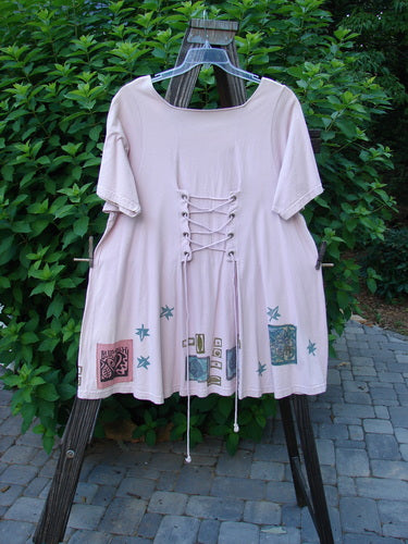1993 Jazz Dress with wide A-line shape, cord lacings, and Star Leaf patch. Size 1, ash pink. Vintage Blue Fish Clothing.