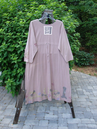 1993 Modernismo Duster Dress Columns Ash Pink OSFA: A pink dress on a swinger, featuring vintage column and leaf theme paint, wooden topped buttons, kangaroo type front pockets, and a scooped neckline.