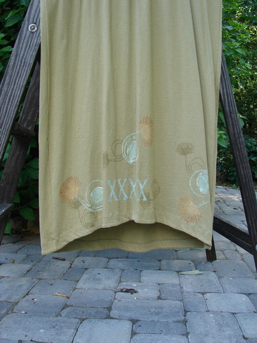 1998 Botanicals Calla Dress Puff Flower Seed Size 2: A green towel on a rack, close-up of a towel, wooden step, stone floor, and black pole.