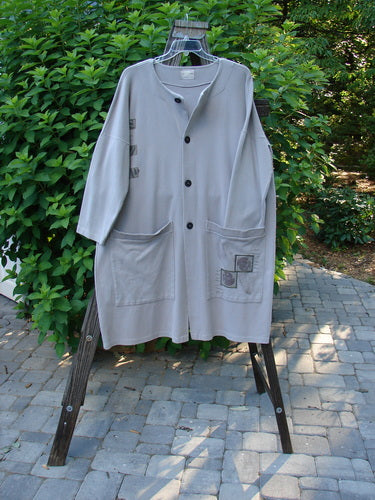 1999 Interlock Long Square Cardigan Jacket Tiny Fern Ash Size 1: A grey coat on a wood rack, part of the Fall Collection.